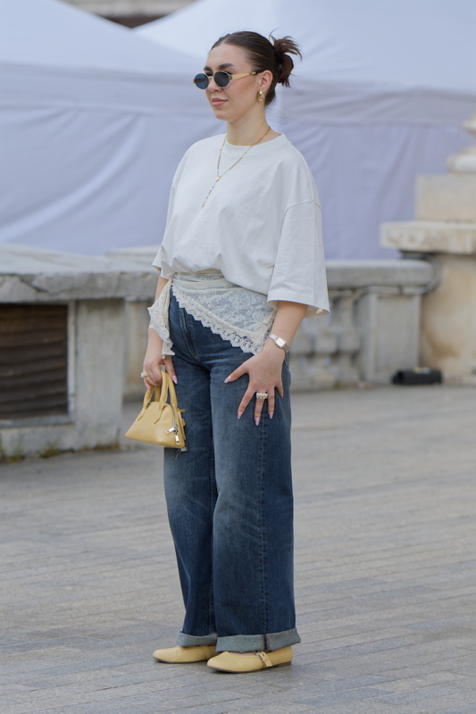 Young woman with a white cotton t-shirt paired with dark wash, high-rise, wide-leg denim jeans